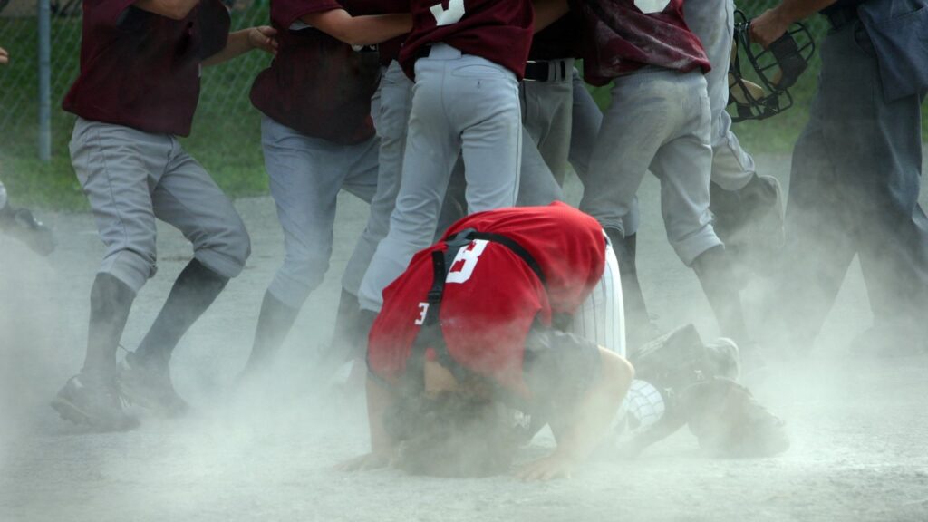 A father coaching a youth baseball team, inspired to create Sudz Fundraising.