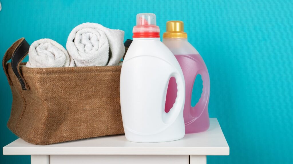 A family happily doing laundry together, surrounded by Sudz Fundraising products, illustrating how laundry can support team fundraising efforts.